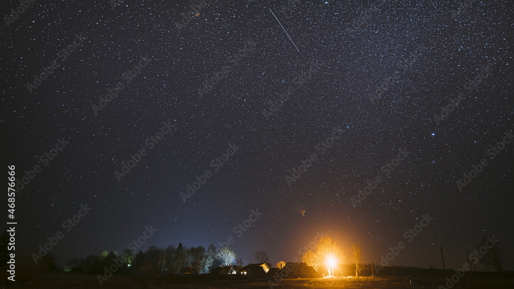 Real Night Sky Stars Above Old Village. Natural Starry Sky Above Rural Countryside Landscape In Belarus
