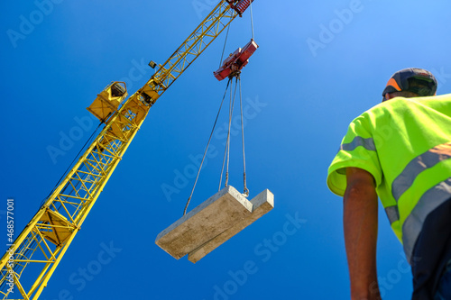 construction worker with crane. Hook cargo crane on the sky background. crane on a construction site