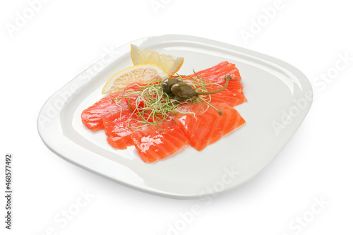 Salmon carpaccio with capers, microgreens and lemon isolated on white