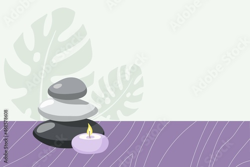 Spa time. Burning candle, stones on wooden table and monster leaves in fashionable modern style. Beauty spa treatment and relax concept for wellness, thai massage, meditation center, home spa.