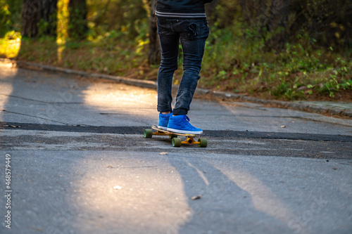 leisure activity, sportive lifestyle, young man riding skateboard, feet and skateboard, close-up © ako-photography