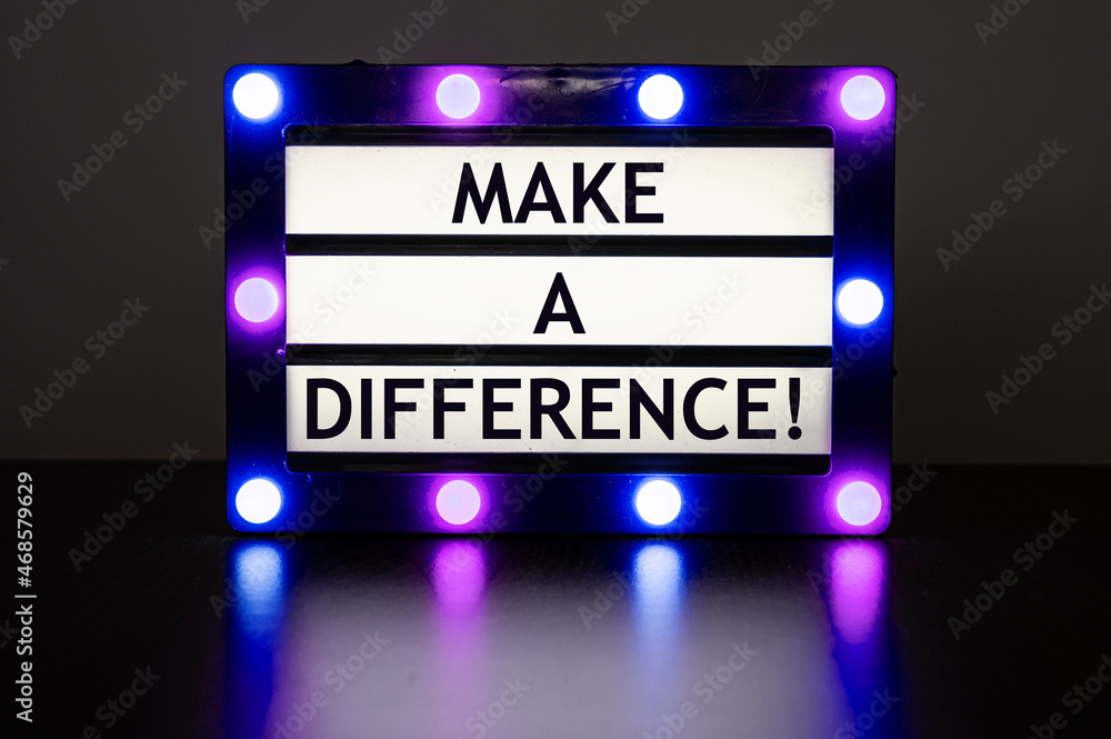 Lightbox with green lights in dark room with words - make a difference!
