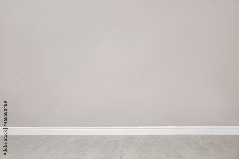 Empty room with beautiful beige wall and wooden floor