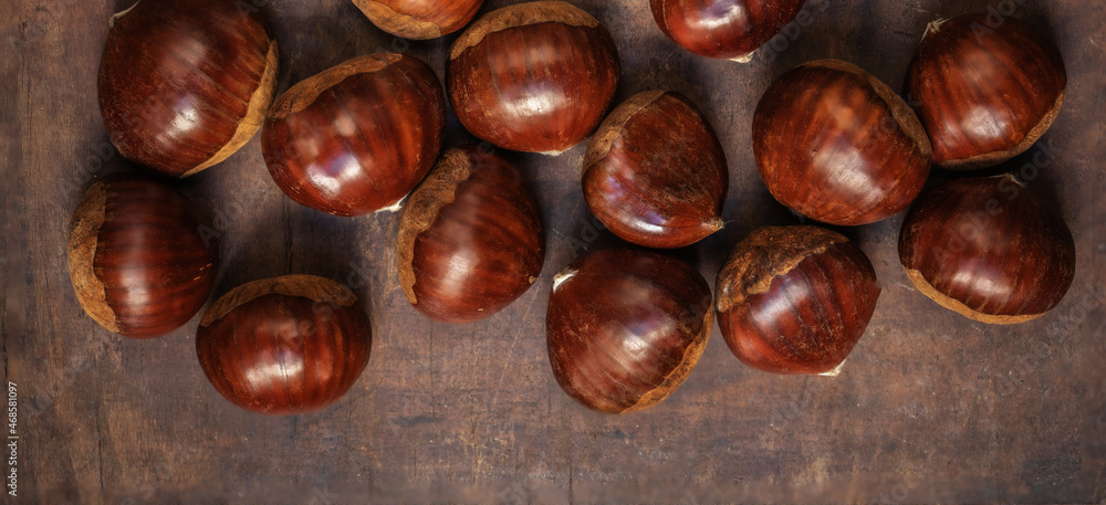 Chestnuts on on an old board with copy space. Autumn fall concept. Horse chestnuts top view. Chestnuts on on an old board with copy space. Autumn fall concept. Horse chestnuts top view.