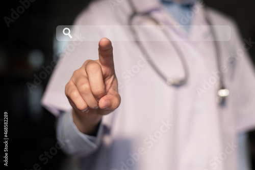 Doctor pressing find information doctor on virtual search bar. concept of use of internet for medical assistance.