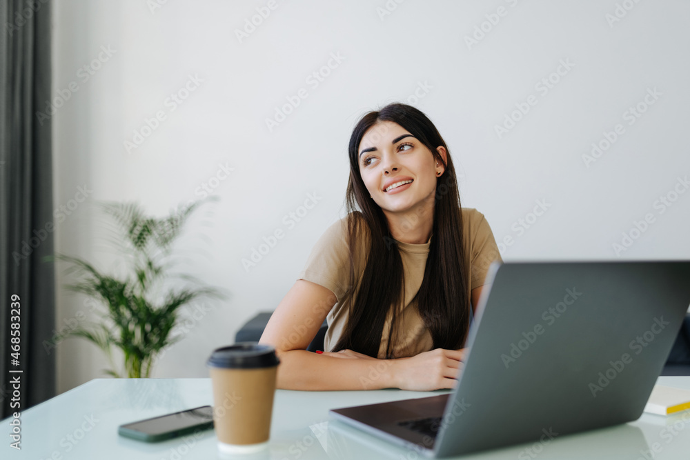 Young Woman using working on laptop and working from home