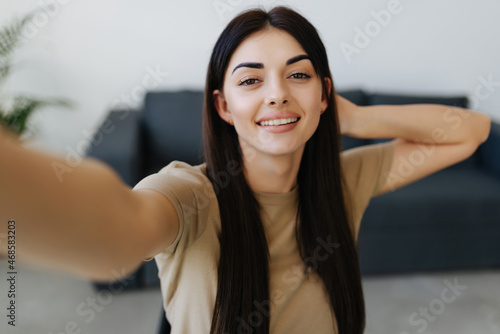 Young attractive woman taking selfie at home