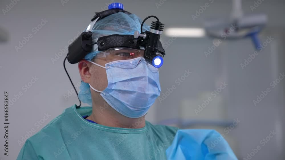 Handsome neurosurgeon in mask working in emergency ward. Portrait of professional surgeon specialist. Handsome neurosurgeon in mask working in emergency ward. Portrait of professional surgeon specialist.