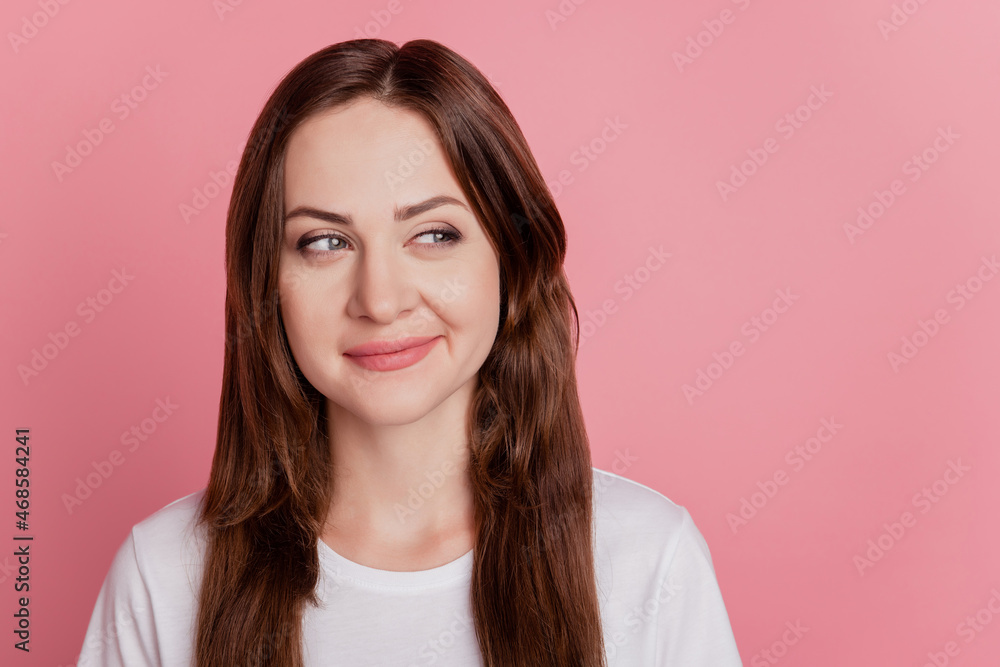 Obraz premium Portrait of charming cunning playful positive girl look empty space on pink background