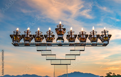 Image depicts Jewish holiday of light Hanukkah with menorah and burning olive...