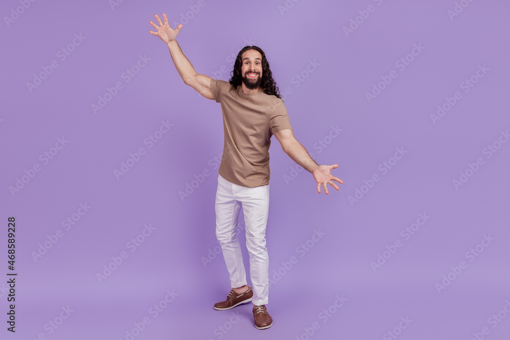 Full length photo of young man amazed excited gesture hands big size measure isolated on purple color background Full length photo of young man amazed excited gesture hands big size measure isolated on purple color background