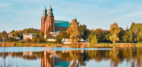 Cathedral in Gniezno town, Poland, on a bright day in Summer reflected in water photo