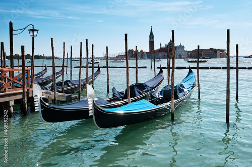 Gondolas moored by Saint Mark square with San Giorgio di Maggiore church in the background. Venice, Venezia, Italy, Europe.