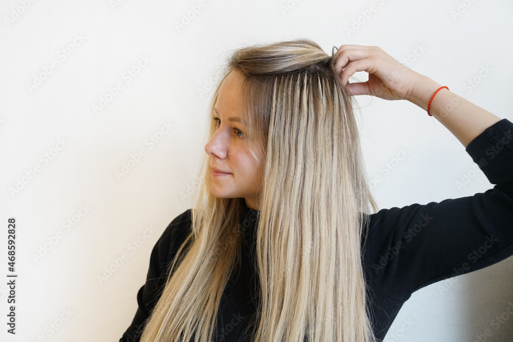 Fototapeta premium Natural Hair extensions blonde woman on a white background. 