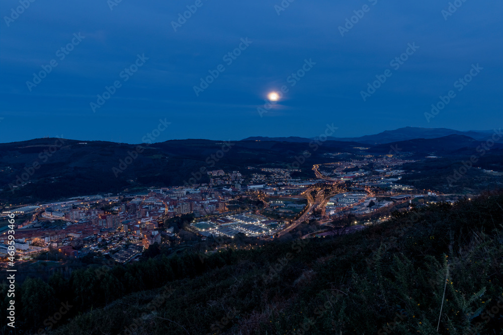 view of the surroundings of Bilbao with a full moon