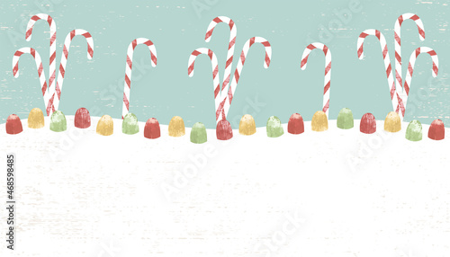 Candy canes and gumdrops in a cut paper style with textures and copyspace
