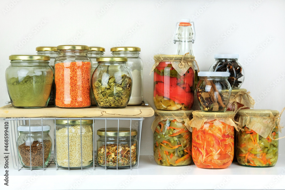 Variety of vegetarian products and fermented foods in glass jars for storage on white wooden table. Healthy vegan cooking, clean eating, zero waste concept. Balanced dieting food. Variety of vegetarian products and fermented foods in glass jars for storage on white wooden table. Healthy vegan cooking, clean eating, zero waste concept. Balanced dieting food.