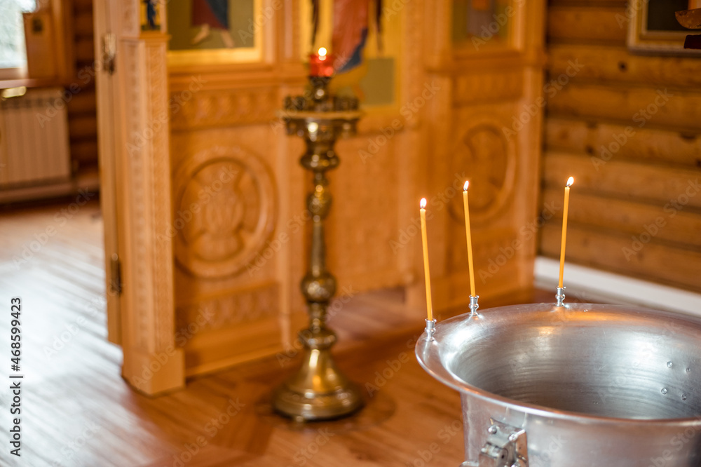 Holy water font for the baptism of children. The rite of initiation into the faith in the Christian temple. Church services - Liturgy of the baptism of children. Christian religious ceremony.