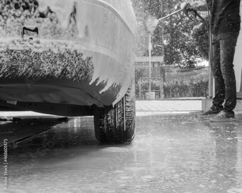 Washing and cleaning car in self service car wash station. Car washing using high pressure water