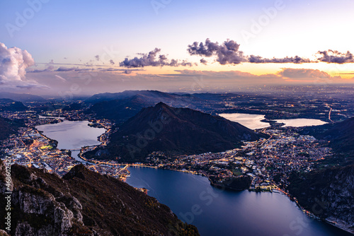 Bild auf Leinwand The city of Lecco, on Lake Como, photographed after sunset from Pian Dei Resinelli, with Brianza and its lakes in the background