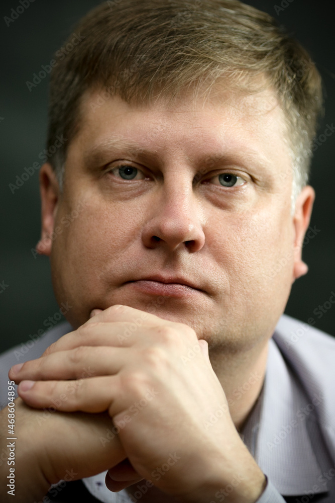 Portrait of beautiful adult light blue-eyed man in a shirt on a gray background. Portrait of beautiful adult light blue-eyed man in a shirt on a gray background.
