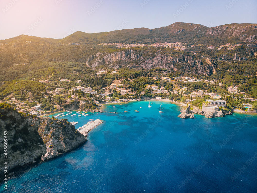 Aerial view of Paleokastritsa bay on a sunny day. Bay with beautiful turquoise water and boats.