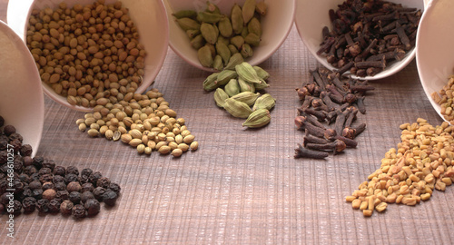 Collection of indian Spices and herbs. Food and cuisine ingredients on wooden background. © Raksha