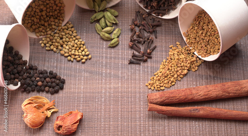 Collection of indian Spices and herbs. Food and cuisine ingredients on wooden background.