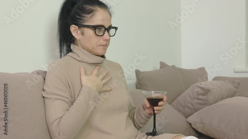 Woman trying to stop hiccups at home photo