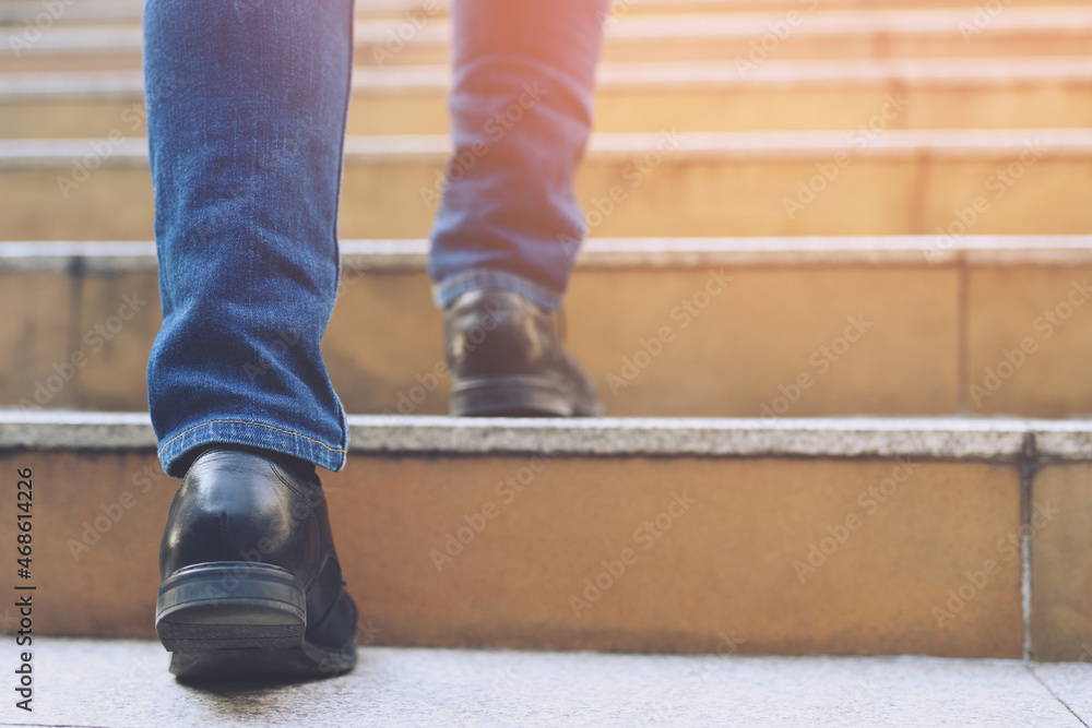 Close up legs shoes of young business man One person walking stepping going  up the stairs