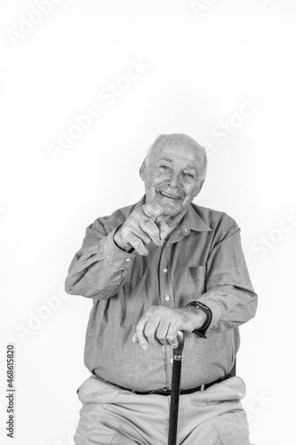 happy elderly man sitting in a chair  giving handsign
