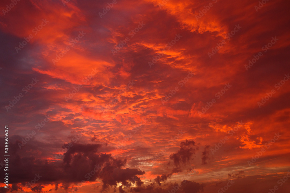 Red-orange sky with clouds before sunrise. Beautiful August landscape with sunrise sky