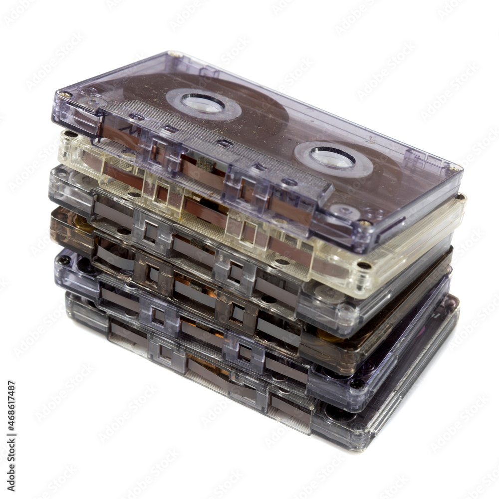 pile of audio compact cassettes on a white background pile of audio compact cassettes on a white background