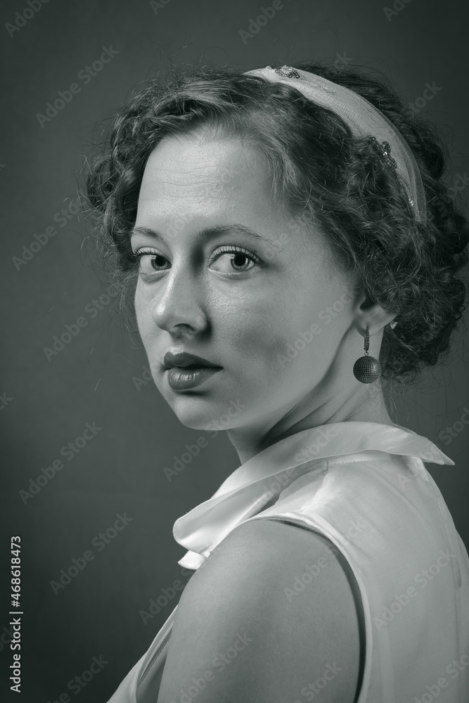 Half-turn portrait of young woman in retro style. Studio toned black and white shot Half-turn portrait of young woman in retro style. Studio toned black and white shot