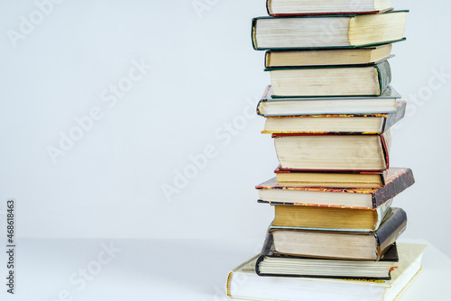 Photos Stack of old books on white background