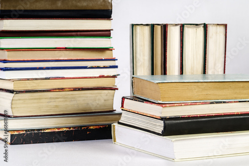 Photos Stack of old books on white background