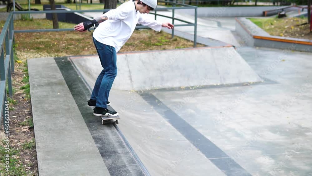 Skateboarder in skate park doing tricks, slow motion Skateboarder in skate park doing tricks, slow motion