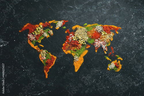 Fototapeta Naklejka Na Ścianę i Meble -  World map - Set of spices and condiments on a black background. Top view.