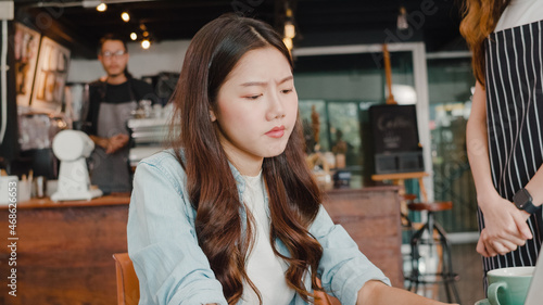 Photography Young Asia freelance lady client talk dispute with millennial waitress feel dissatisfied with cafe bad service, mad disappointed customers speak with staff complain about wrong order coffee shop