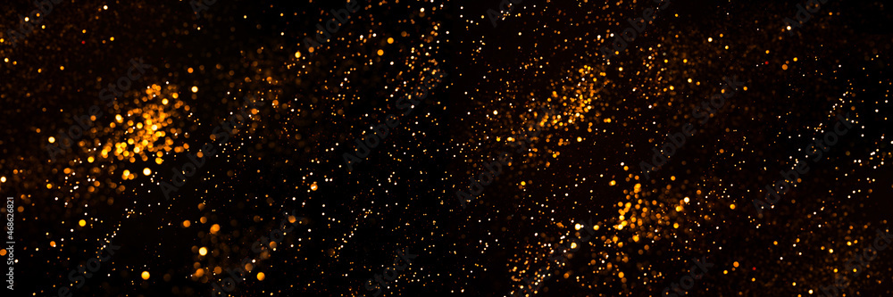 Golden abstract bokeh on black background. Golden abstract bokeh on black background.