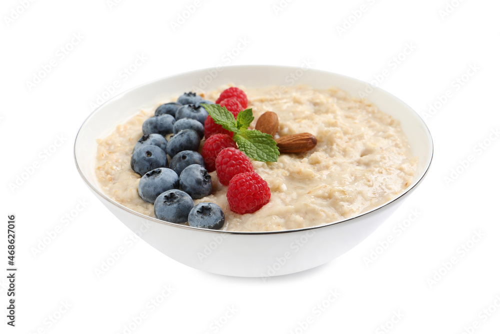 Tasty oatmeal porridge with raspberries, blueberries and almond nuts in bowl on white background Tasty oatmeal porridge with raspberries, blueberries and almond nuts in bowl on white background