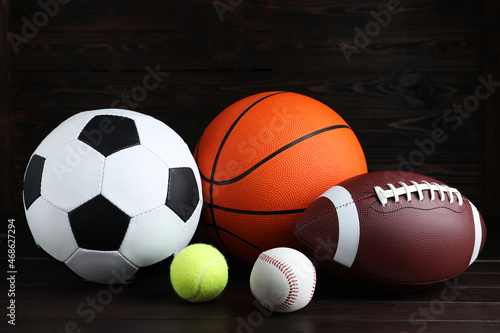Set of different sport balls on wooden table