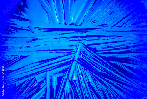 Abstract natural ice texture toned in neon blue color