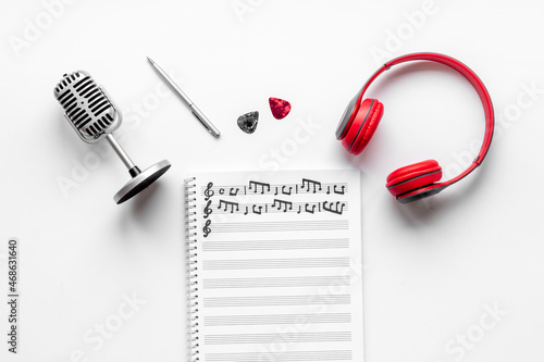 Sheets with music notes and headphones. Compose music concept