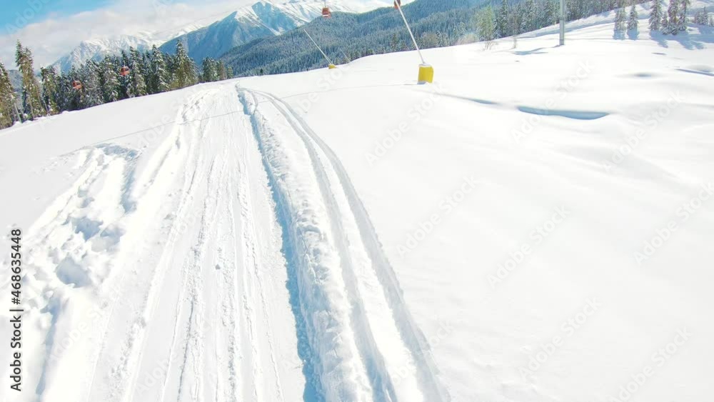Extreme sport in winter. First-person view snowboarder on snowboard running down the slope in Ski resort. Winter sport and recreation concept, leisure outdoor activities. Extreme sport in winter. First-person view snowboarder on snowboard running down the slope in Ski resort. Winter sport and recreation concept, leisure outdoor activities.