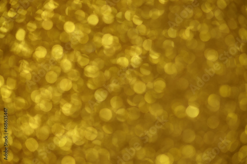 Gold sparkle blurry background with dots texture blurred 