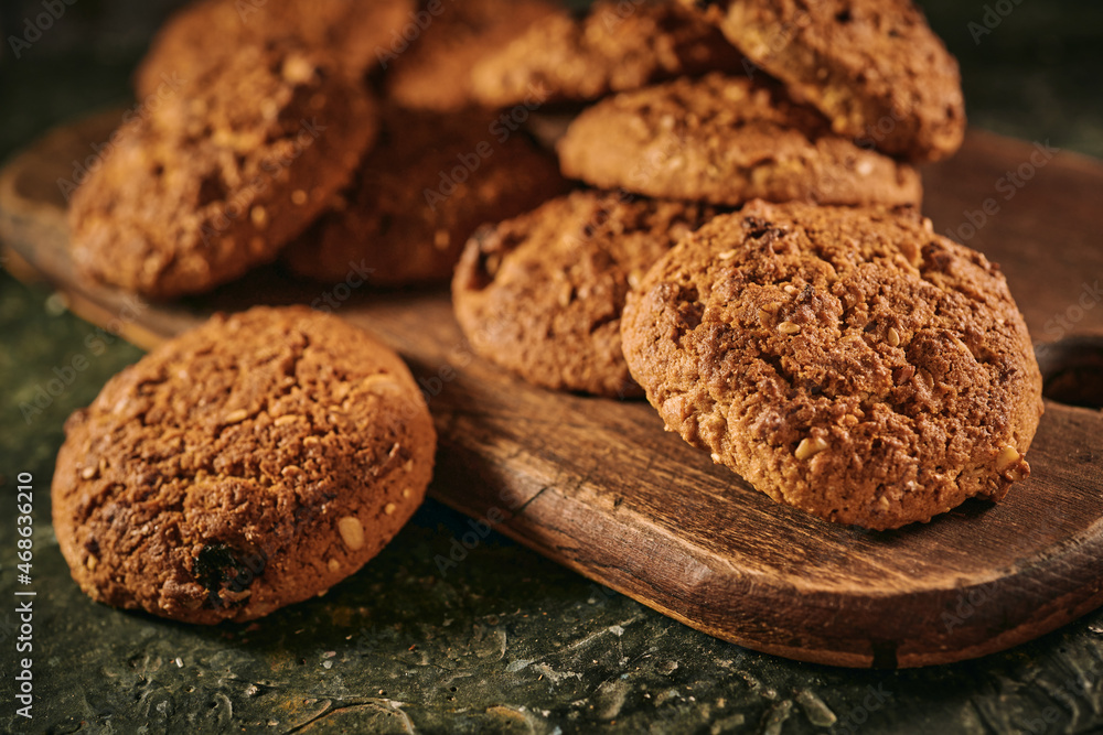 Pile of oat cookies on wooden table, close-up, selective focus Pile of oat cookies on wooden table, close-up, selective focus