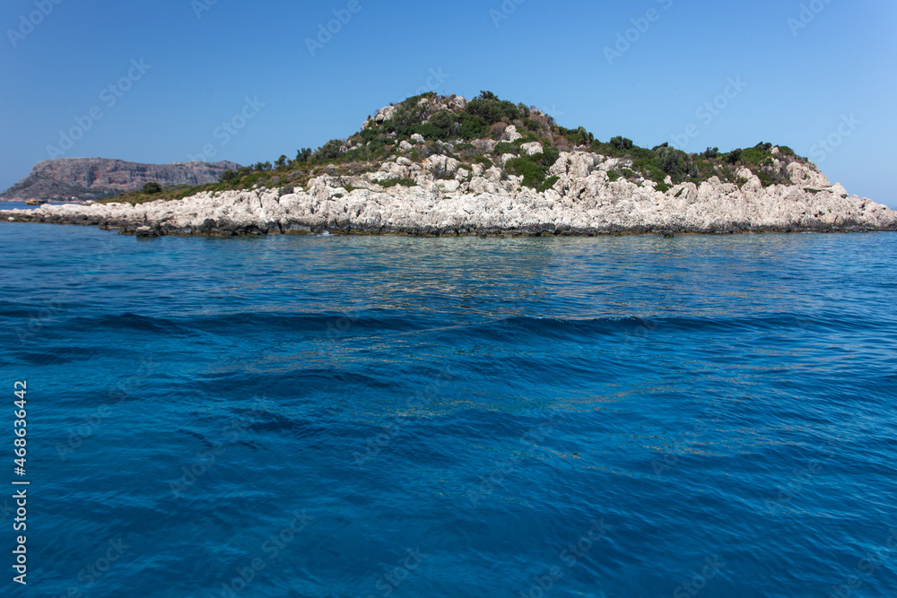 Beautiful uninhabited islands surrounded by crisp blue Mediterranean sea near the coast of Kas, Antalya, Turkey.
