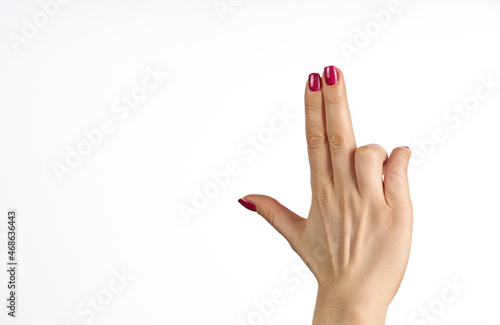   a woman's hand with a red manicure pointing up against a white background photo