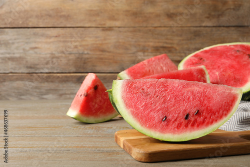 Delicious fresh watermelon slices on wooden table. Space for text